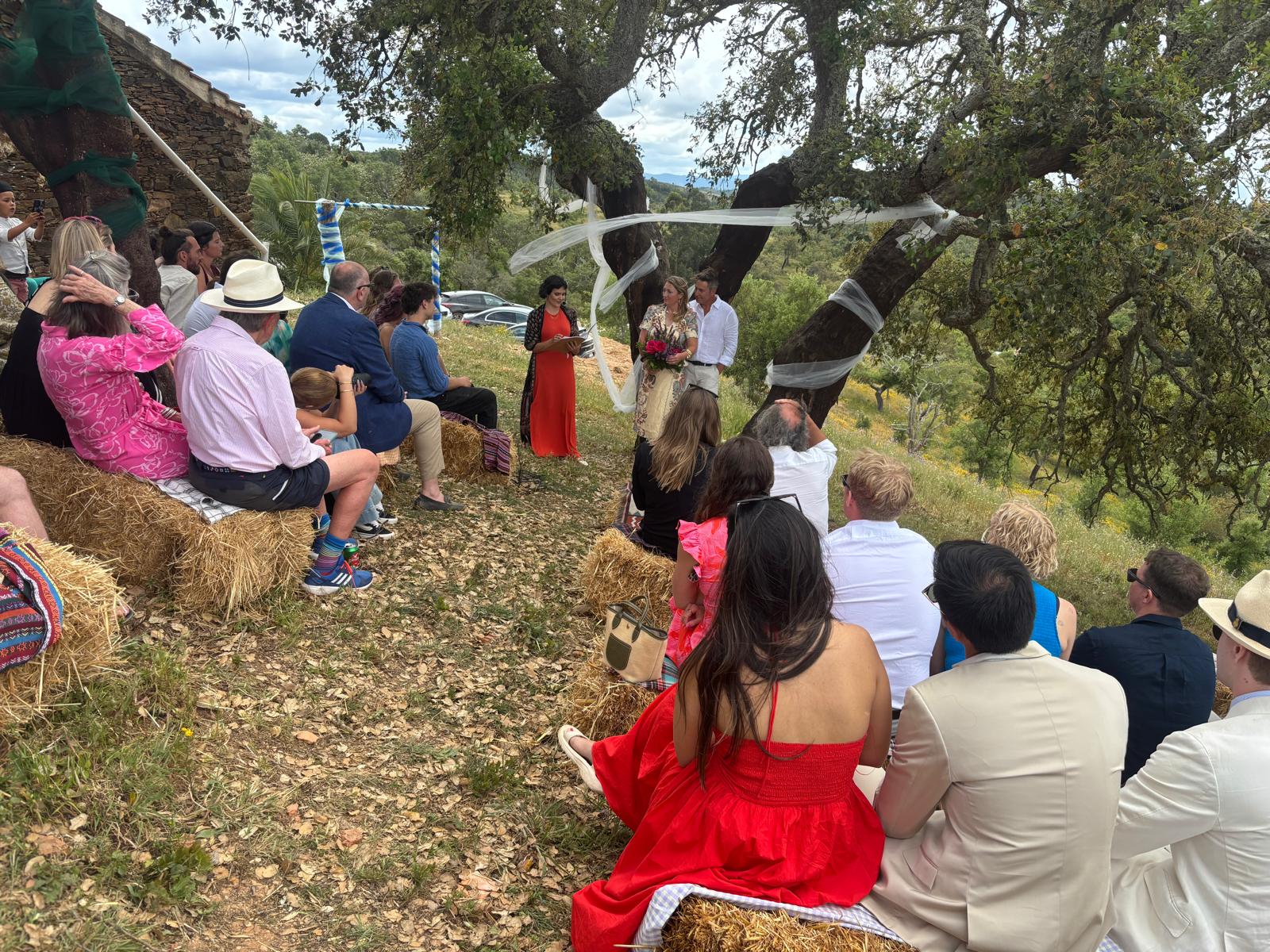 Rustic wedding ceremony set under cork oak tree